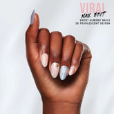 Close-up of a model's hand wearing Salon Perfect 352 ViralNail Edit Pink Shell Press On Nail.
